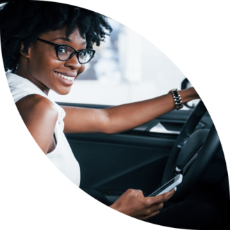 Smiling driver checking her new auto insurance rate from her car
